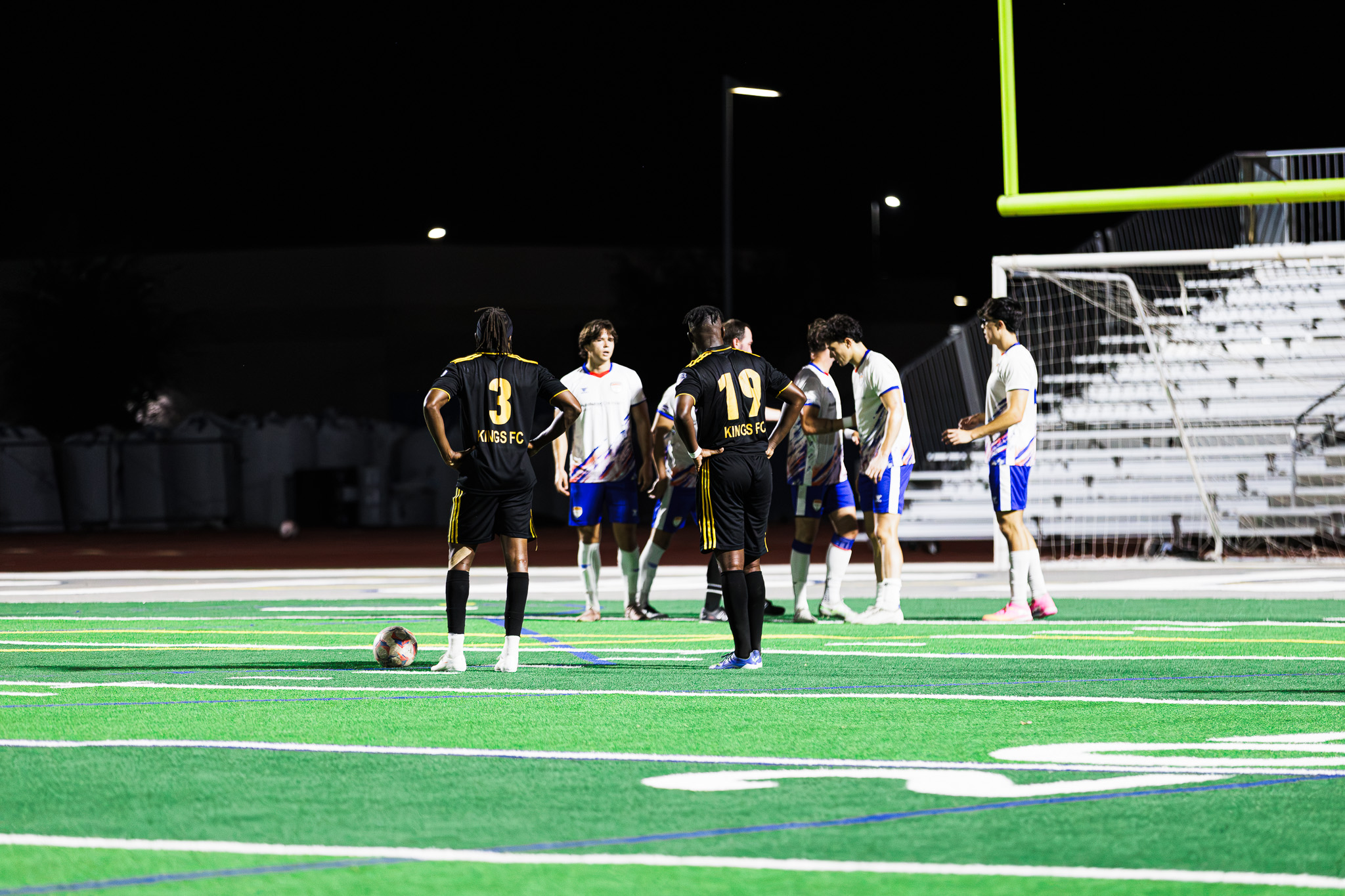 Kings FC players gathered on the pitch.