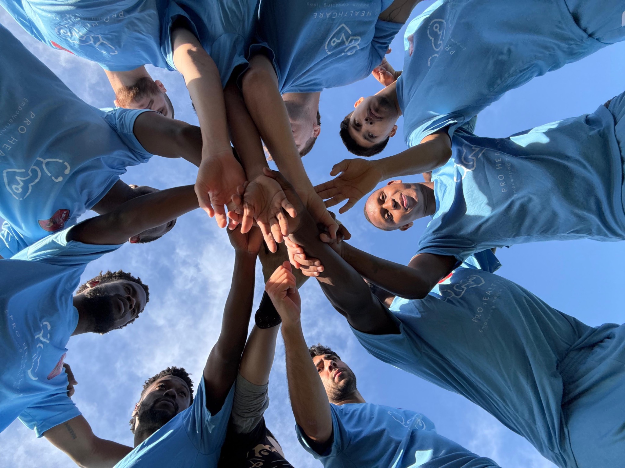 Kings FC players joining hands.